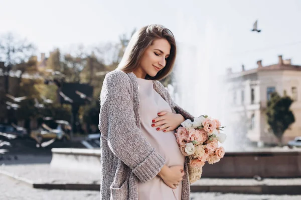 通りを歩く花のきれいな妊婦さん 茶色の目をした美しいブロンドの女の子 プロの化粧品 幸せで気楽な妊娠 — ストック写真