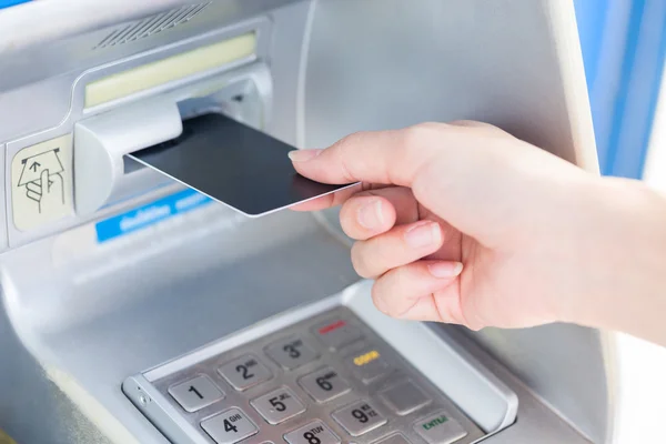 Close up hand inserting card into ATM. — Stock Photo, Image