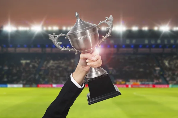 Soccer manager team holding trophy champions in the stadium. — Stock Photo, Image