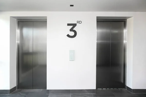 Two Silver Elevator Door White Hallway Stock Picture