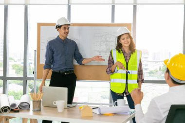 Bir grup çeşitlilik mühendisi ofis veya inşaatta iş görüşmeleri veya toplantılar yapıyor. Mühendislik konsepti.