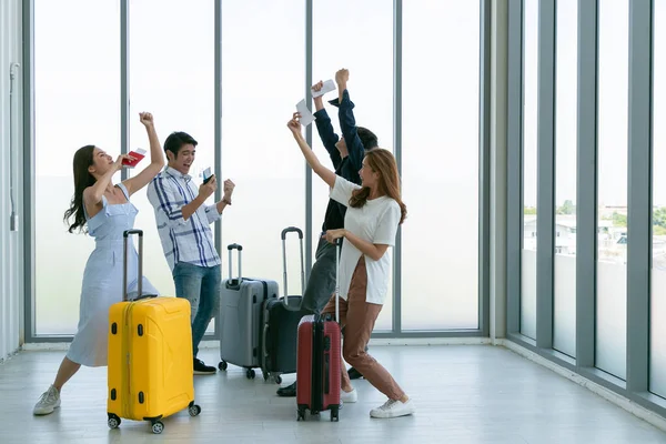 Young Group of happy people in airport. Holiday travel.