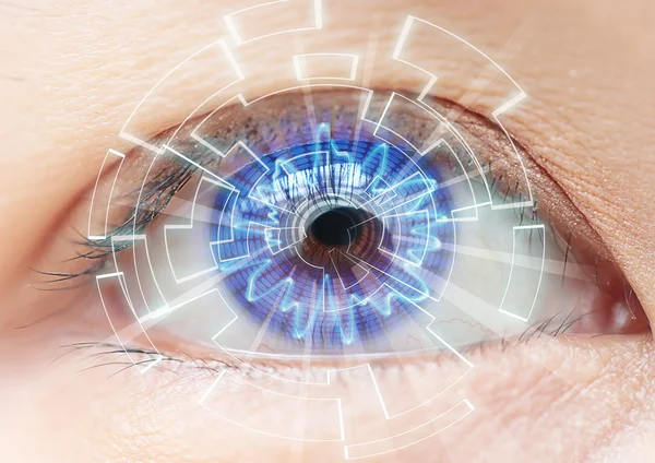 Close-up of woman's blue eye. High Technologies in the futuristi — Stock Photo, Image