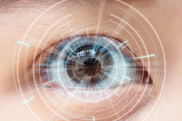 Close-up of woman's brown eye. High Technologies in the future Stock Photo