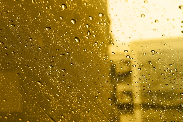 Rétroviseur goutte d'eau pare-brise dans la ville au coucher du soleil . — Photo