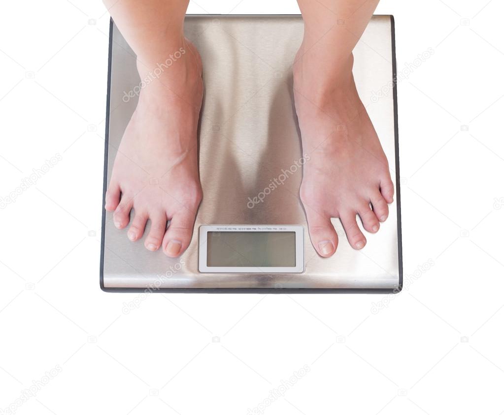 close-up of woman feet weighing scale isolated on white backgrou