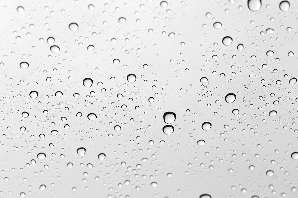 Water drop on glass mirror background.