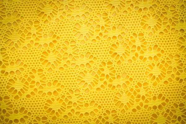 Żółty koronki tekstura tkanina tło. — Zdjęcie stockowe