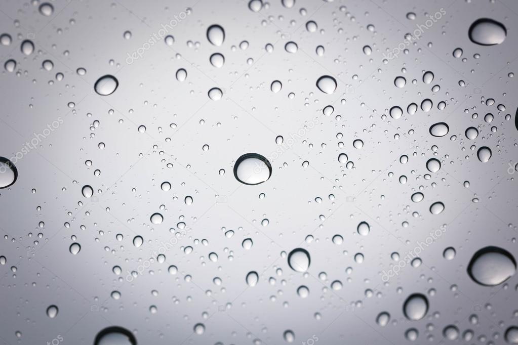 Water drop on glass mirror background.