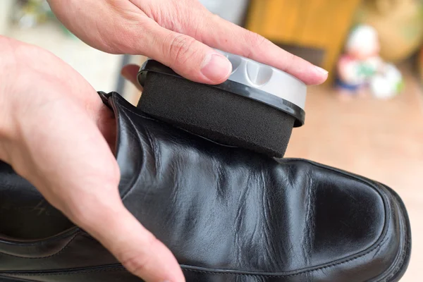 Hands polish leather black shoes. — Stock Photo, Image