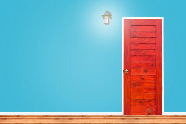 Wooden door and lamp with isolated blue wall texture. — Φωτογραφία Αρχείου