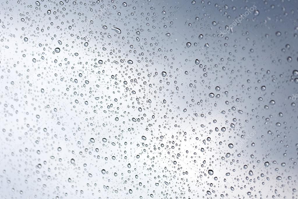 Rainy water drop on glass mirror background.