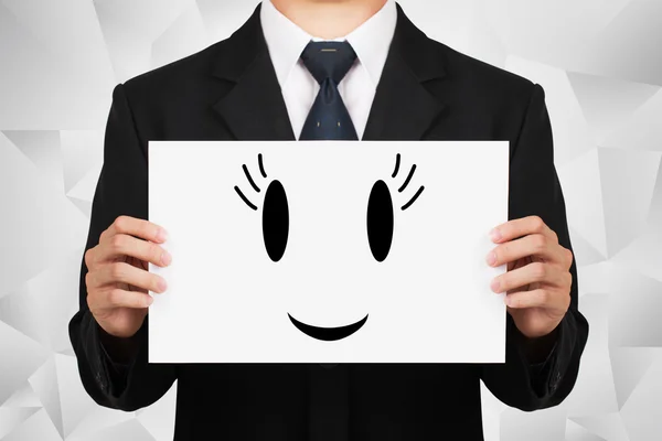 Businessman holding on whiteboard with icon smile. — Stock Fotó