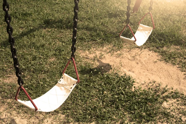 Playground swing lonely in the park and garden. — ストック写真