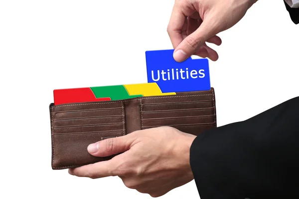 Businessman hands pulling folder Utilities concept on brown wall — Stockfoto