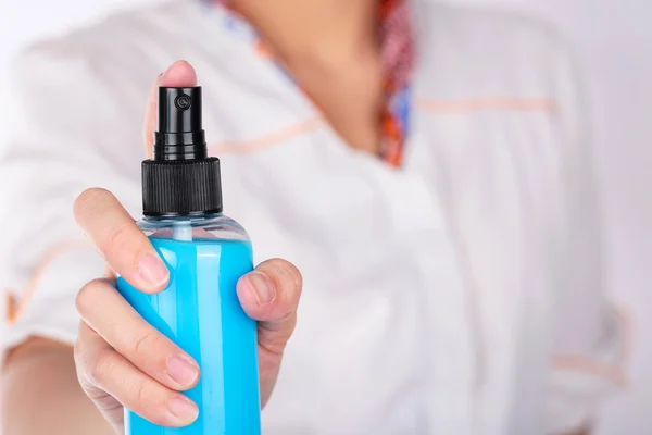 Women holding spray blue bottle. — Stock Photo, Image