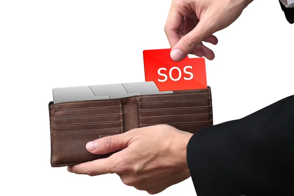 Бизнесмен руки тянет папку SOS концепция на коричневый бумажник . — стоковое фото