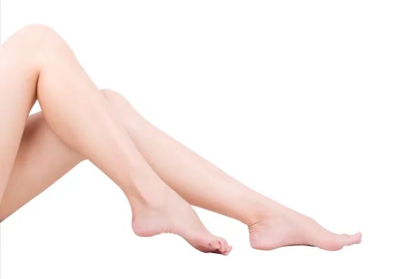 Schöne Beine schlanke Frauen isoliert weißen Hintergrund. — Stockfoto
