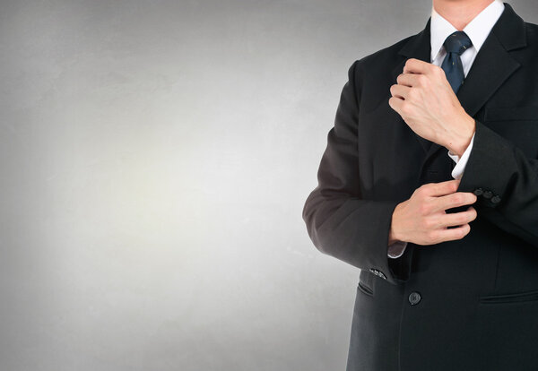 Businessman button up in suit on concrete background texture.