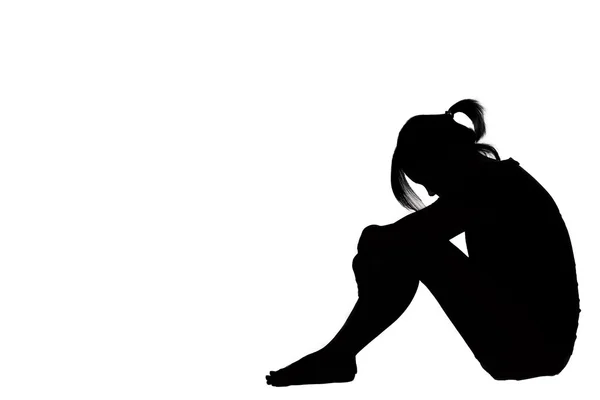 A woman sad depressed sitting along isolated on white background — Stock Photo, Image