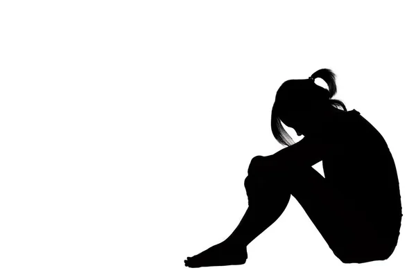 A woman sad depressed sitting along isolated on white background Stock Picture