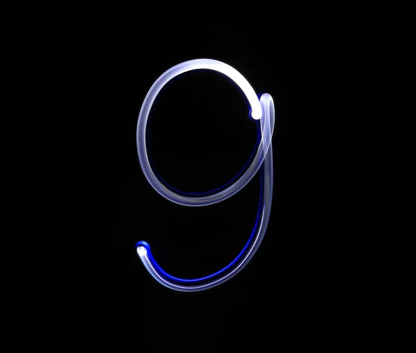 Nove azul luz dígito mão escrita sobre fundo preto . — Fotografia de Stock