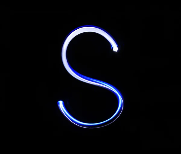 S Sierra alphabet hand writing blue light  over black background — Stock Photo, Image