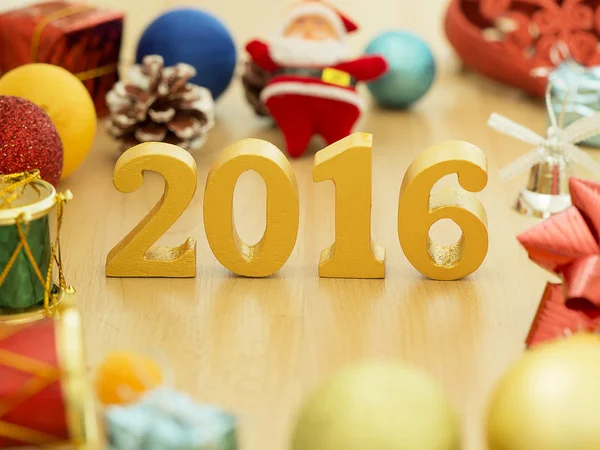 Text of gold 2016, make from wood. Golden year 2016. New year decoration, closeup on 2016 text. Happy new year 2016. Gold 2016 on wood floor with copy space at the bottom for your text.