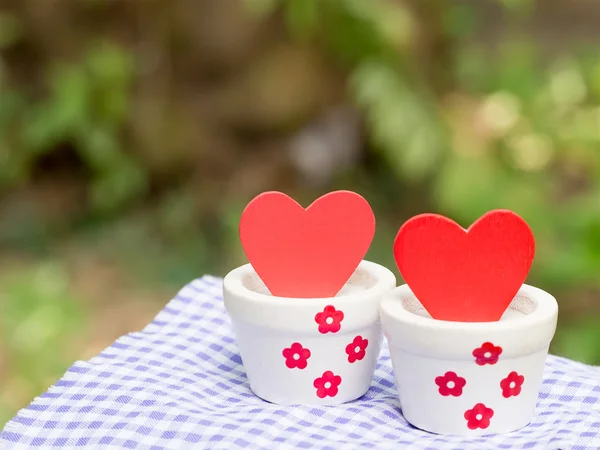 Valentines day background with red hearts in white pots. Love concept.