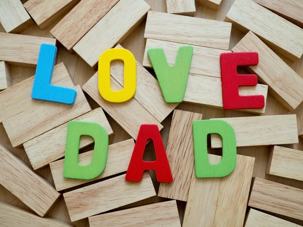 Love dad. Happy Father\'s Day celebrations. Love dad word from colorful of wood on wooden block in background. Father\'s day.