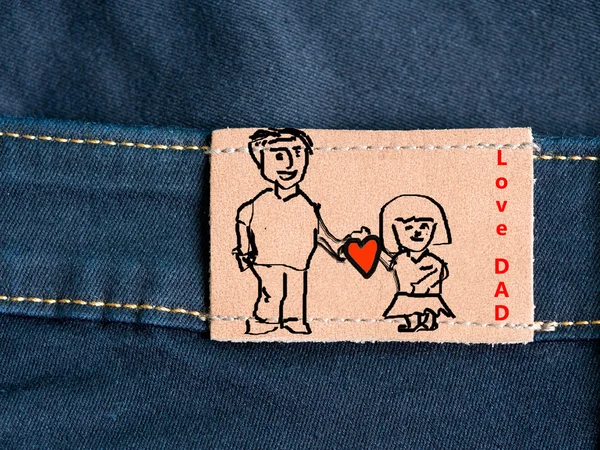 Happy Father\'s Day celebrations. Love dad. Father and daughter draw on brown tag of blue jean. Father\'s day.