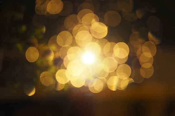 Bokeh amarillo circular abstracto en fondo oscuro, luces de burbuja de oro por la noche. Fondo de Navidad Bokeh con diseños de círculos o estrellas borrosas que brillan, brillo fondo mágico — Foto de Stock