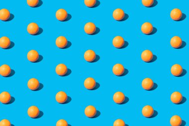 Canlı mavi arka plana karşı taze portakalla yaratılmış yaratıcı desen. Minimum güneş ışığı düzlüğü.