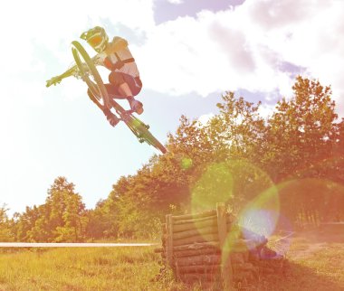 Sportsman on a mountain bike is flying in a jump from a springboard clipart