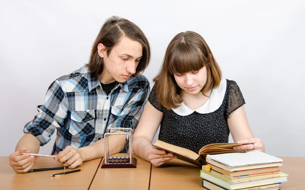 The teenager looks in the book , which reads girl Stock Photo