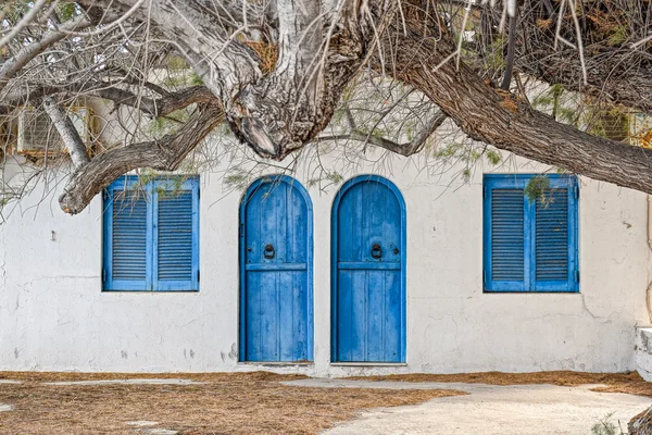 Stone wall with arched wooden doors — Stock Photo, Image