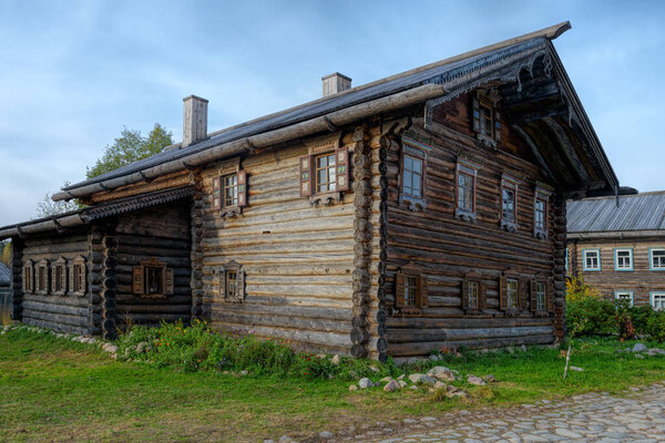 VERKHNIYE MANDROGI, RUSSIA - Oct 03, 2020: Example of well preserved large two-storey multi-purpose northern Russia ancient wooden wood farmhouse in a craft and museum tourist centre Verkhniye Mandrogi