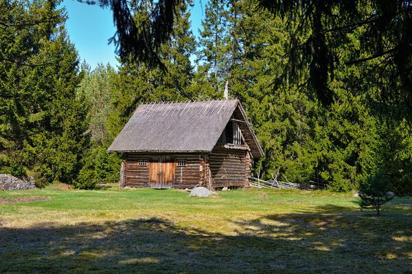 Old log barn with a thatched roof