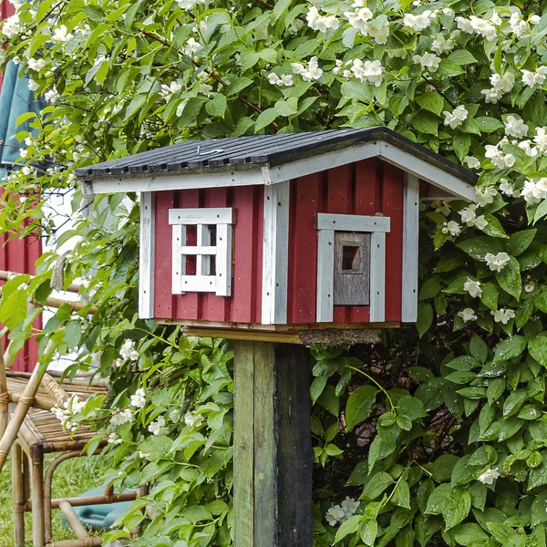Птичник в форме деревянного красноохристого домика — стоковое фото