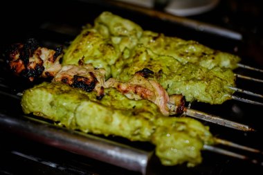 Selective Focus image on Chicken Reshmi Kebab and Chicken Haryali Kebab on Barbeque Grill.
