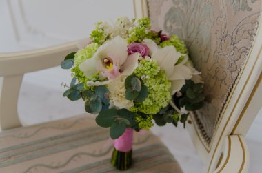 Sandalyenin üstüne yalan taze bahar çiçekleri küçük ihale buket