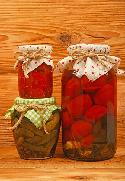 Three jars of pickles over vintage wood — Stock Photo, Image