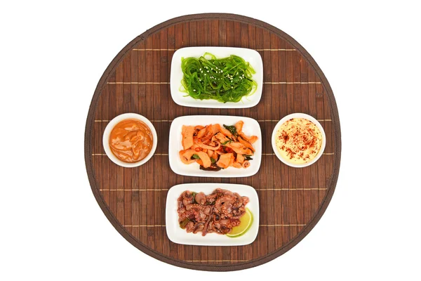 Three seafood salads on bamboo mat — Stock Photo, Image