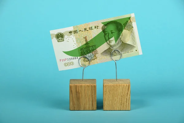 Chinese yuan growth illustrated over blue — Stock Photo, Image