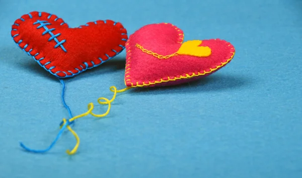 Dois corações de arte artesanal feltro, rosa e vermelho no azul — Fotografia de Stock