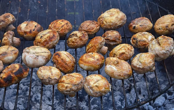 White champignons mushrooms on grill — Stock Photo, Image