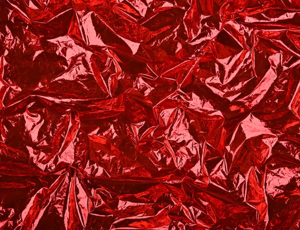 Close Festivo Sfondo Astratto Rosso Spiegazzato Foglio Plastica Metallica Lucida — Foto Stock