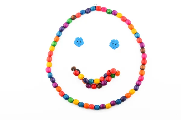 Smile of colorful wooden beads isolated on white — Zdjęcie stockowe