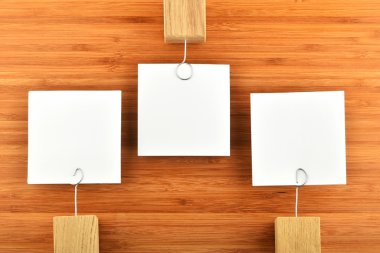 Three paper notesin different directions on wooden background