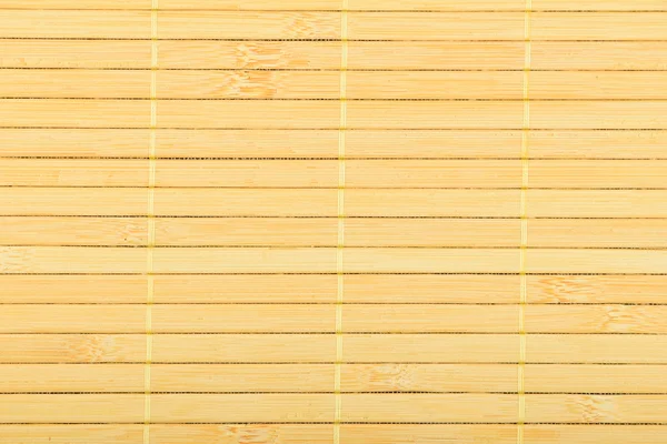 Alfombra trenzada de mimbre de madera de bambú amarillo claro fondo —  Fotos de Stock